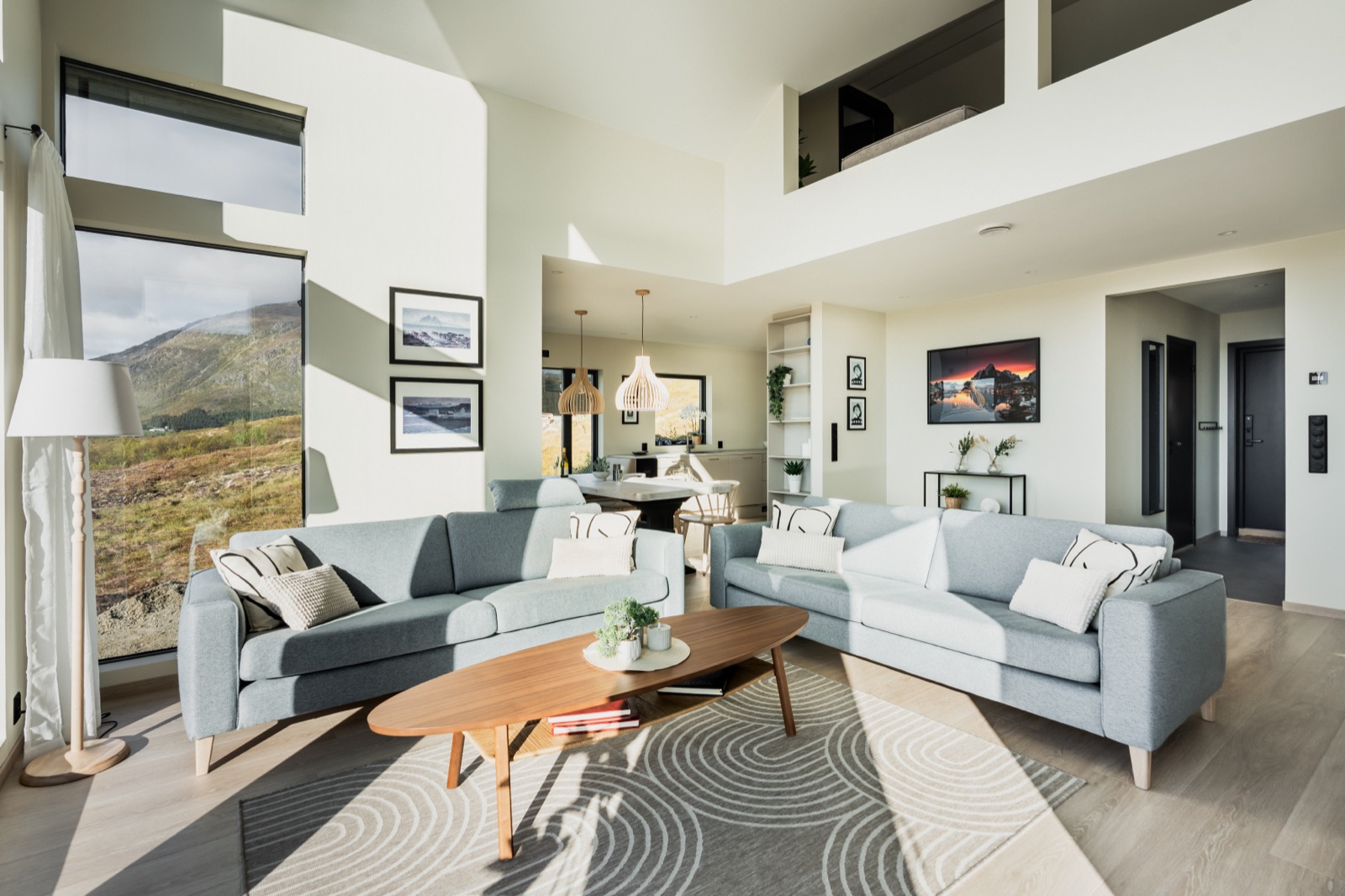 Double-height living room with twin sofas and the mezzanine above