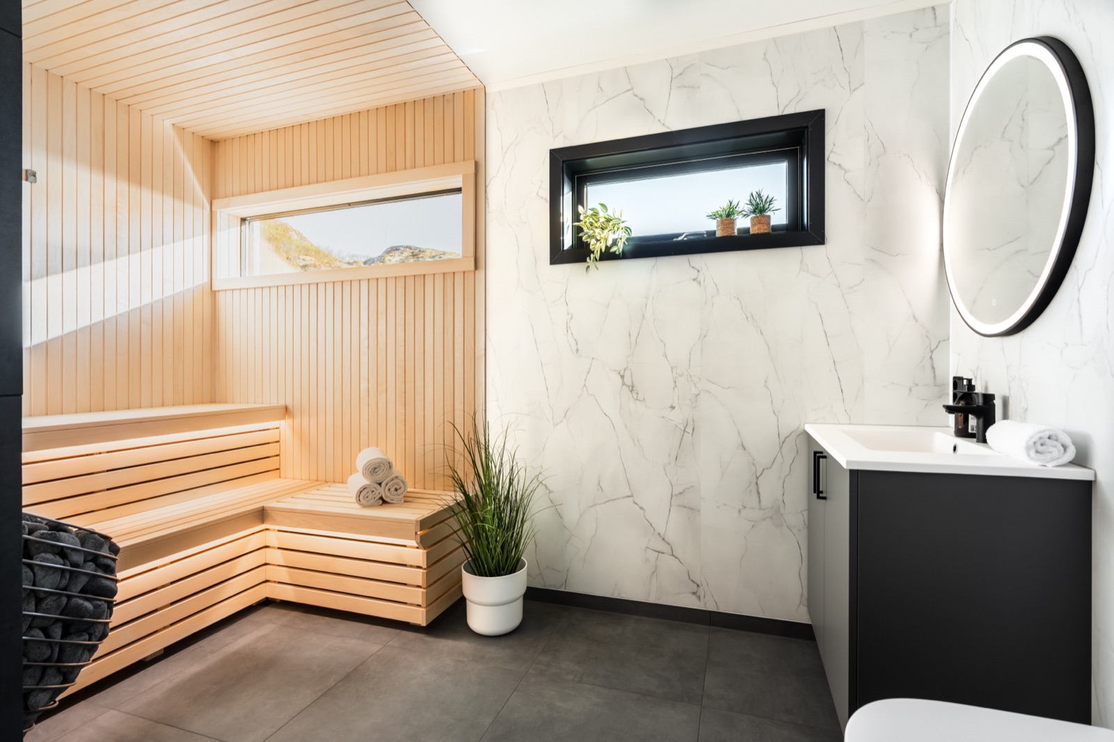 Private light-wood sauna beside the marble bathroom