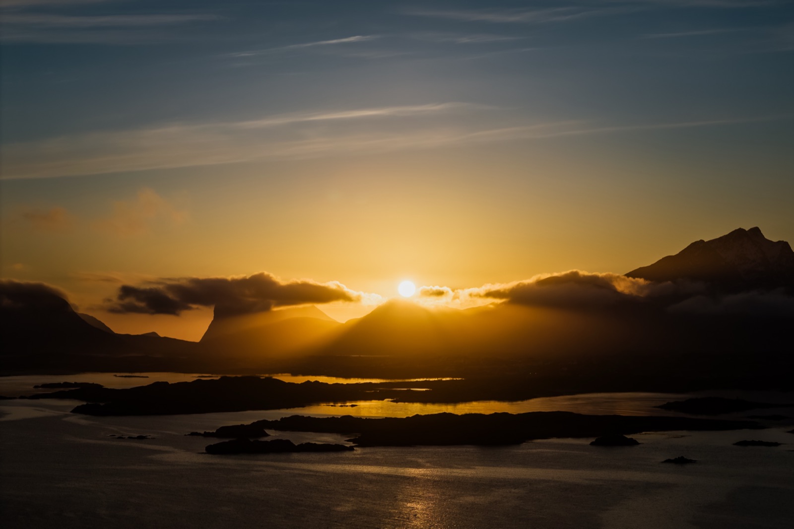 Midnight sun over the islands and water near Leknes